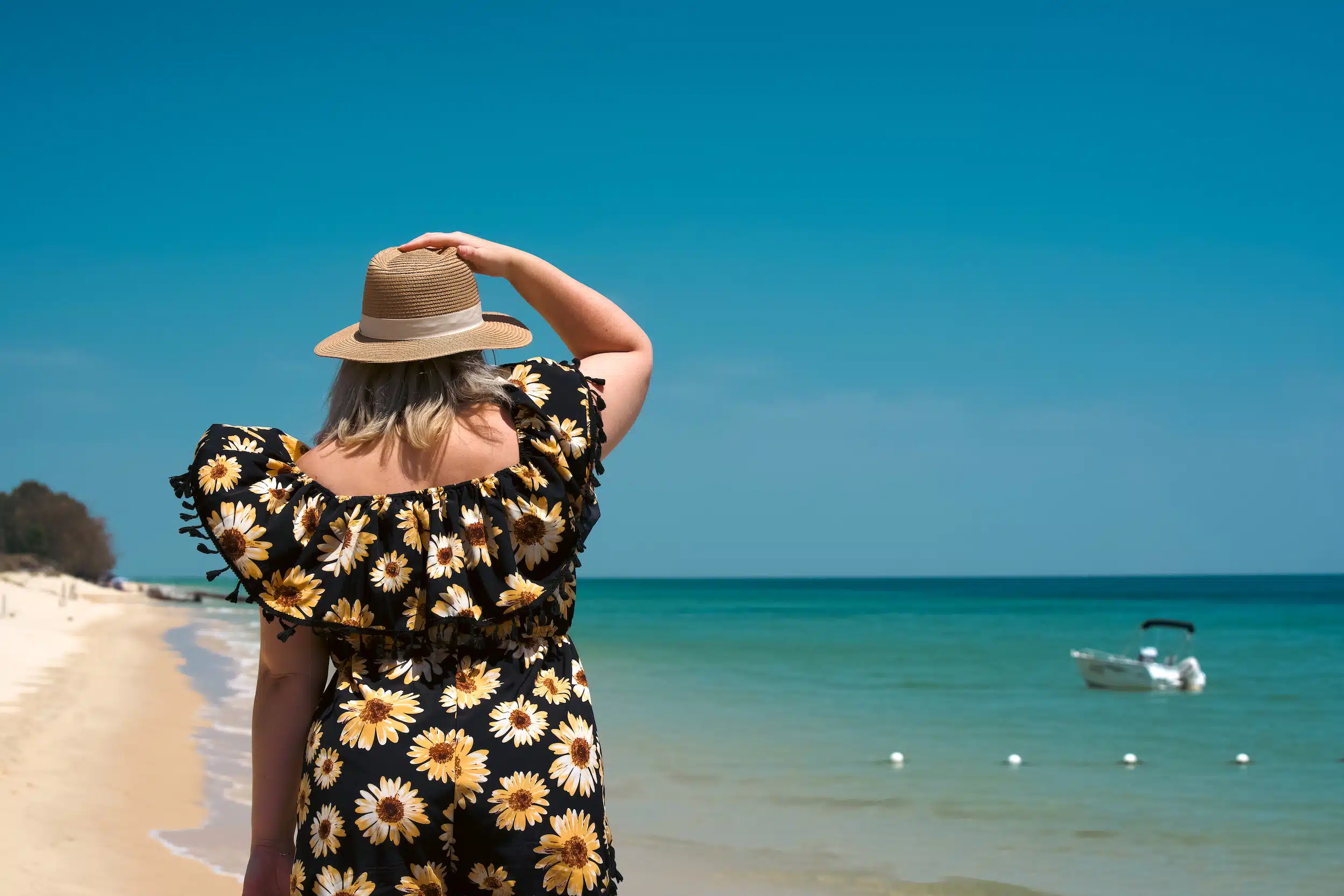 turquoise blue waters on Moreton Island with a boat in the background